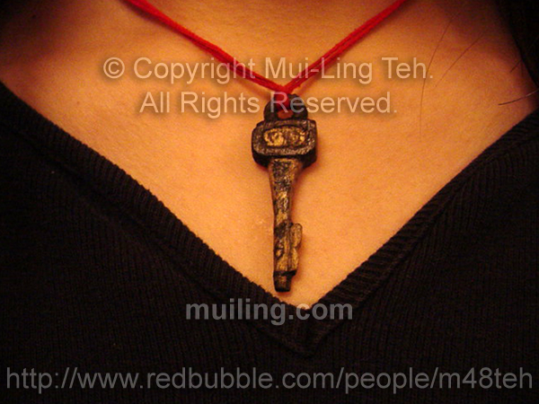 Hand carved wooden key pendant made by Mui-Ling Teh at age 17