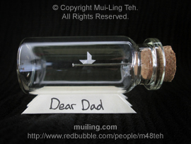 Miniature origami boat sailing along a needle in a bottle by Mui-Ling Teh, with a personalized "Dear Dad" message written on the yellow base.