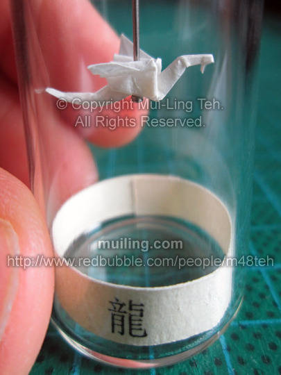 Cute white miniature origami dragon in a bottle from the Shengxiao Chinese circle of animals zodiac