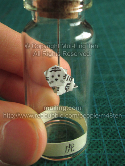 Cute white miniature origami tiger in a bottle from the Shengxiao Chinese circle of animals zodiac