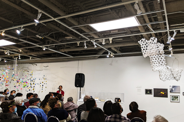 Artist Mui-Ling Teh presenting her origami at the Japanese Canadian Cultural Centre Gallery