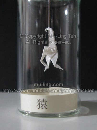 Cute white miniature origami monkey in a bottle by Mui-Ling Teh. Part of the miniature Chinese circle of animals zodiac series.