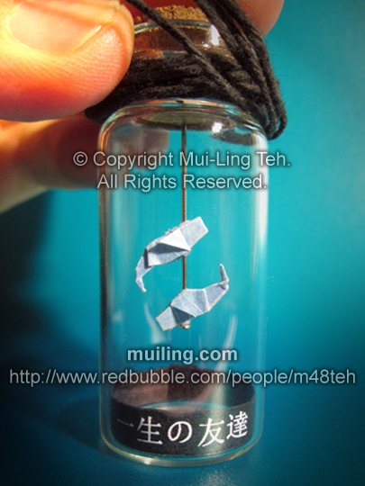 Miniature origami pisces in a bottle by Mui-Ling Teh, with a black label saying "Lifetime Friends" in Japanese
