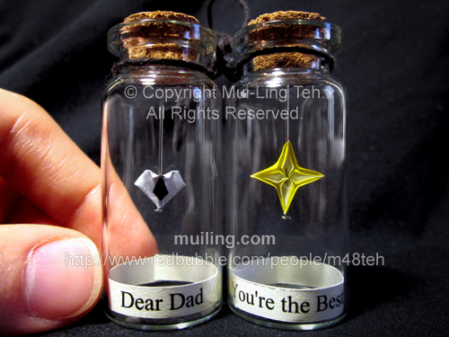 Miniature origami neck-tie heart and yellow star in bottles with labels "Dear Dad" and "You're the Best!"