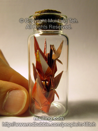 Four colourful origami cranes in a small bottle by miniature origami artist Mui-Ling Teh