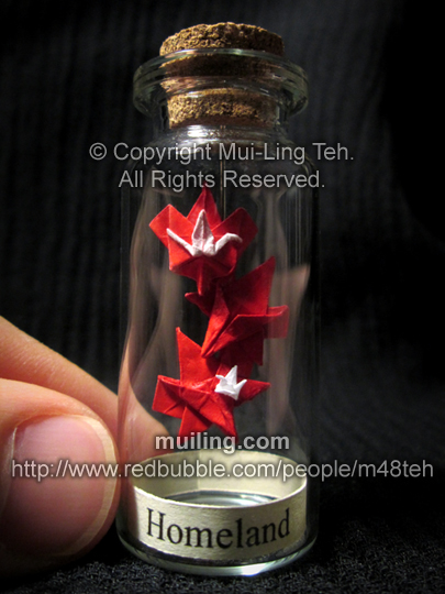 Canadian-themed miniature origmai crane leaf, maple leaves, and crane in a bottle, with the word Homeland by Mui-Ling Teh