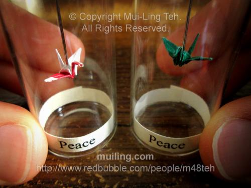 Miniature origami cranes in small bottles by Mui-Ling Teh folded with coloured paper