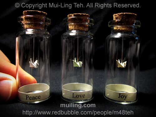 Miniature origami cranes in small bottles by Mui-Ling Teh
