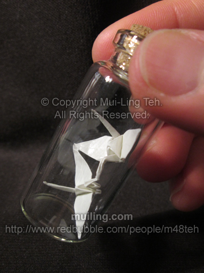 origami kissing cranes in a small bottle by miniature origami artist Mui-Ling Teh