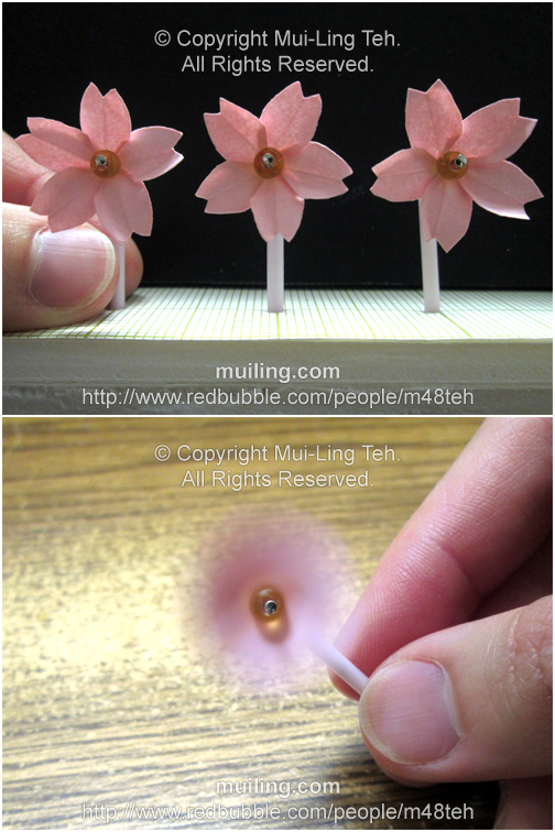 Cute little pink origami cherry blossom pinwheels by Mui-Ling Teh that can spin when blown on.