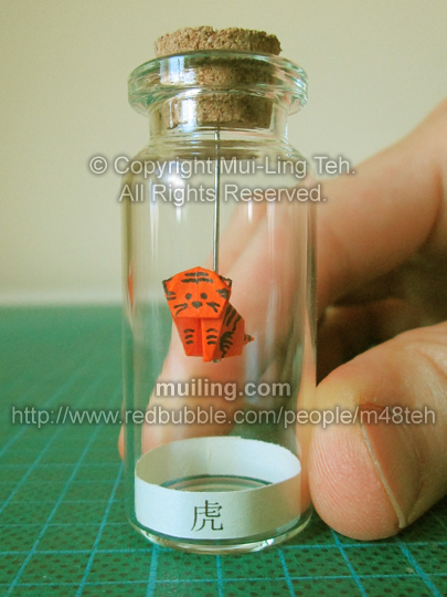 Miniature origami tiger in a small bottle by Mui-Ling Teh
